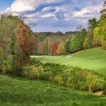Panoramic view of a lush green golf course at Iron Horse Golf Club. Smooth