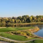 Panoramic view of a lush green golf course at Iron Horse Golf Club. Smooth