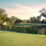 Panoramic view of a lush green golf course at Iron Horse Golf Course. Smooth