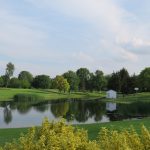 Panoramic view of a lush green golf course at Ironwood Golf Course. Smooth