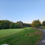 Panoramic view of a lush green golf course at Iroquois Golf Course. Smooth