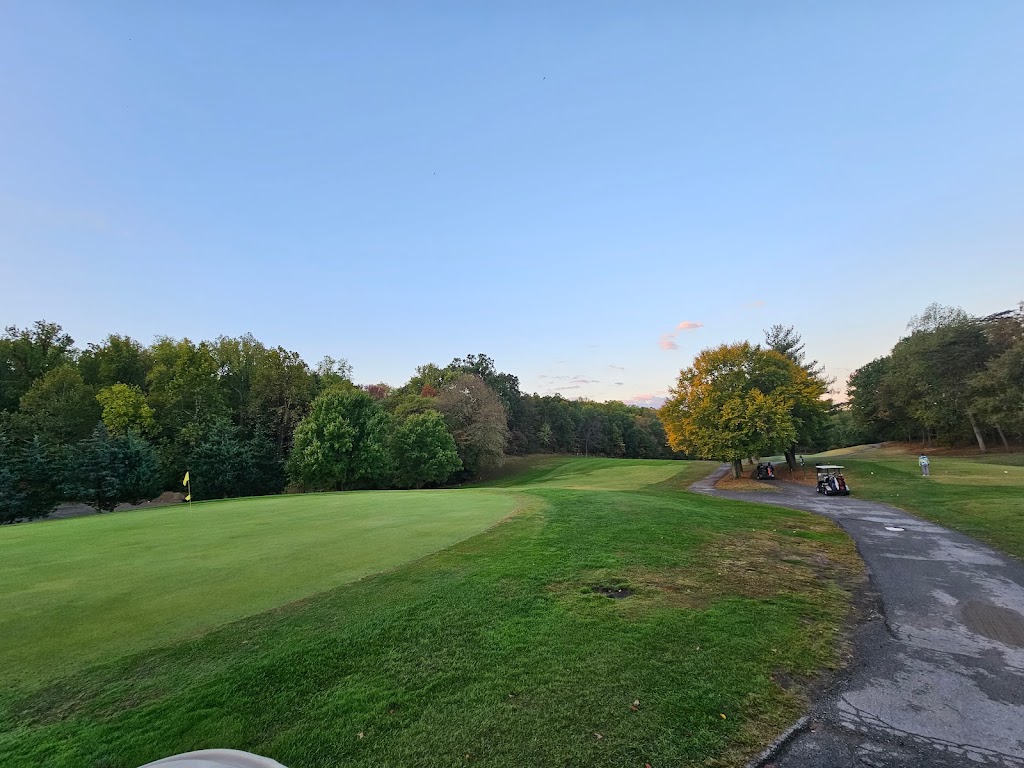 Panoramic view of a lush green golf course at Iroquois Golf Course. Smooth