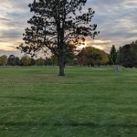 Panoramic view of a lush green golf course at Irv Warren Memorial Golf Course. Smooth