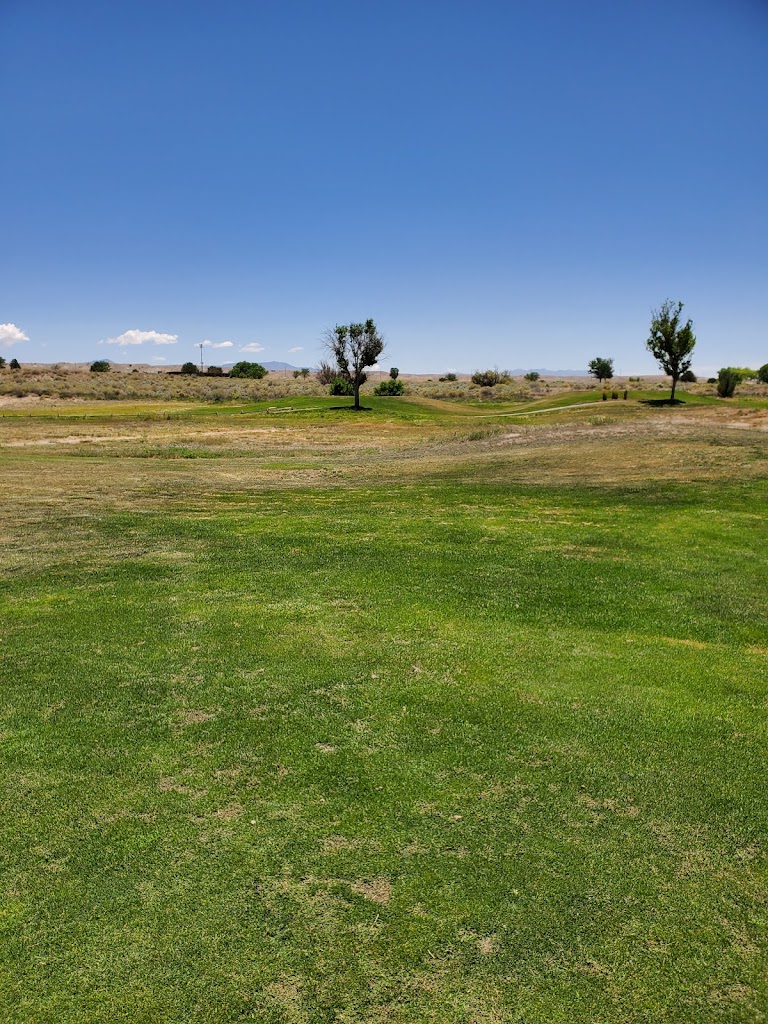 Panoramic view of a lush green golf course at Isleta Golf Club. Smooth