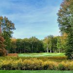 Panoramic view of a lush green golf course at Jack Frost National Golf Club. Smooth