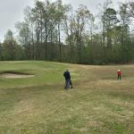 Panoramic view of a lush green golf course at Jack Stephens Youth Golf Academy. Smooth