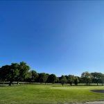 Panoramic view of a lush green golf course at Jackson Park Golf Course. Smooth