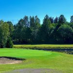 Panoramic view of a lush green golf course at Jackson Park Golf Course. Smooth