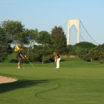 Panoramic view of a lush green golf course at Jamestown Golf Course. Smooth