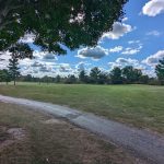 Panoramic view of a lush green golf course at Jaycee Public Golf Course. Smooth