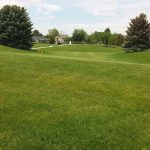 Panoramic view of a lush green golf course at Jerome Country Club. Smooth