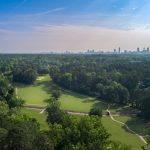 Panoramic view of a lush green golf course at John A. White Golf Course. Smooth