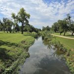 Panoramic view of a lush green golf course at John Conrad Regional Golf Course. Smooth