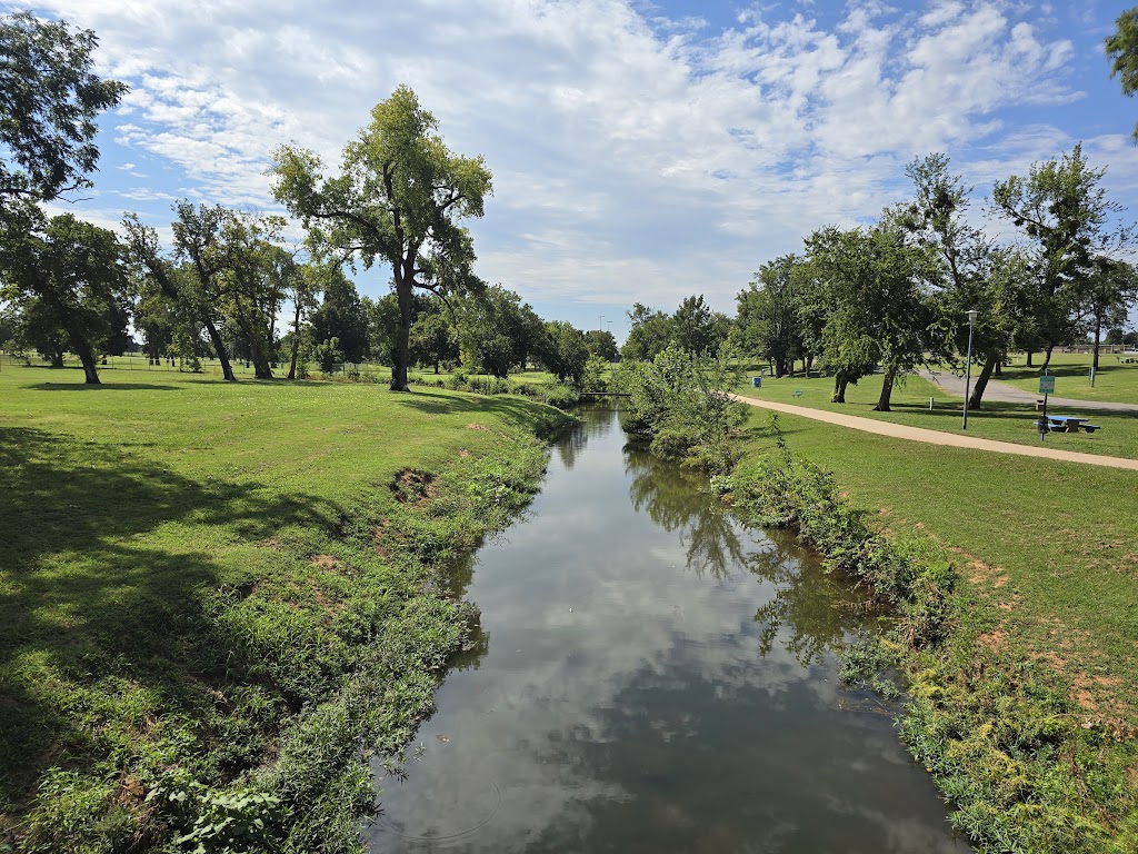 Panoramic view of a lush green golf course at John Conrad Regional Golf Course. Smooth
