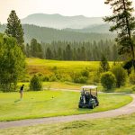 Panoramic view of a lush green golf course at Jug Mountain Ranch. Smooth