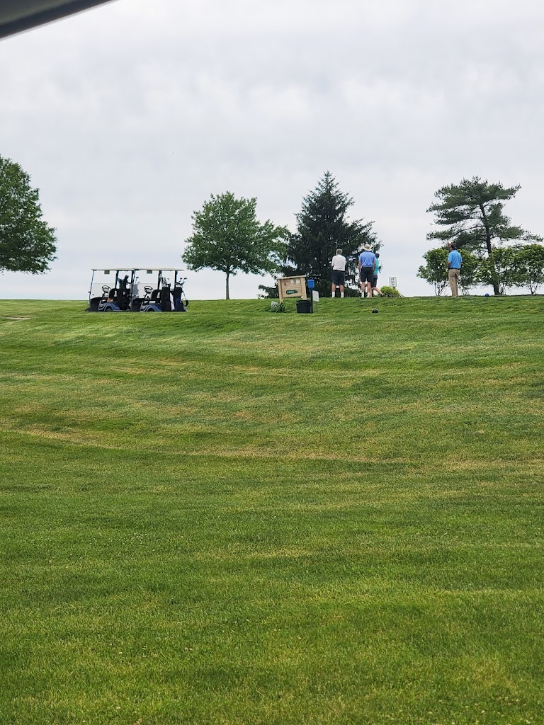 Panoramic view of a lush green golf course at Juniper Hill Golf Course. Smooth