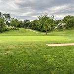 Panoramic view of a lush green golf course at Kansas City Country Club. Smooth
