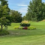 Panoramic view of a lush green golf course at Kellogg Golf Course. Smooth