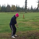 green grass with the flag in the hole.
