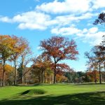 Panoramic view of a lush green golf course at Keney Park Golf Course. Smooth