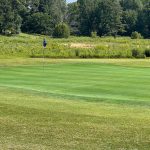 Panoramic view of a lush green golf course at Kentucky Dam Golf Course. Smooth