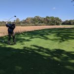 green grass with the flag in the hole.