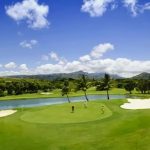 Panoramic view of a lush green golf course at Kiahuna Golf Club. Smooth