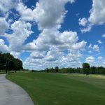 Panoramic view of a lush green golf course at Kinderlou Forest Golf Club. Smooth
