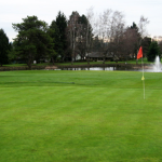Panoramic view of a lush green golf course at King City Public Golf Course. Smooth