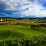 Panoramic view of a lush green golf course at King's Deer Golf Club. Smooth