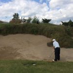 green grass with the flag in the hole.