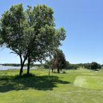Panoramic view of a lush green golf course at Kirkman's Lakeview Golf Course. Smooth