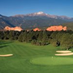 Panoramic view of a lush green golf course at Kissing Camels Golf Course. Smooth