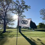 green grass with the flag in the hole.