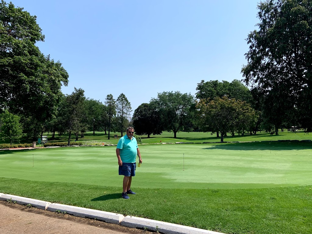 Panoramic view of a lush green golf course at Krueger-Haskell Golf Course. Smooth