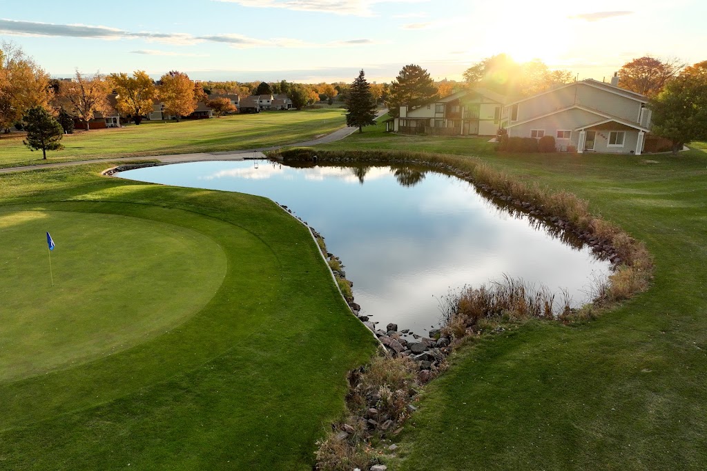 Panoramic view of a lush green golf course at Lake Arbor Golf Course. Smooth