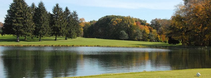 Panoramic view of a lush green golf course at Lake Arthur Golf Club. Smooth