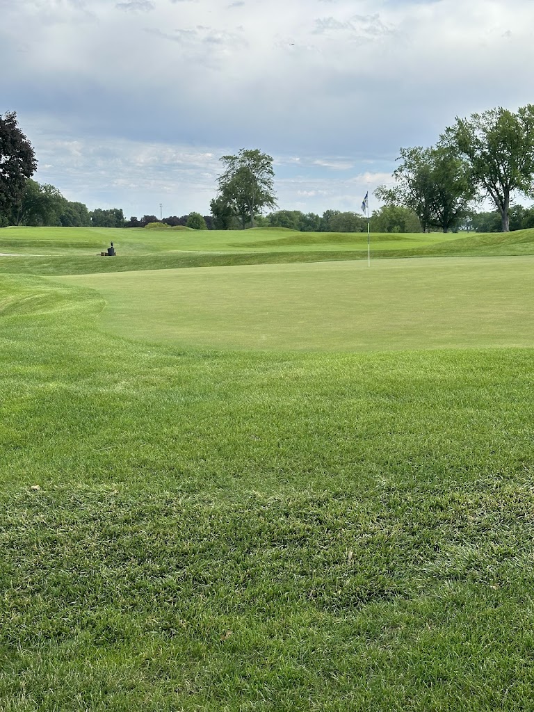 Panoramic view of a lush green golf course at Lake Geneva Country Club. Smooth
