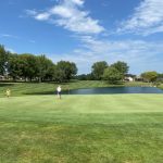green grass with the flag in the hole.