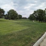Panoramic view of a lush green golf course at Lake Panorama National Golf Course. Smooth