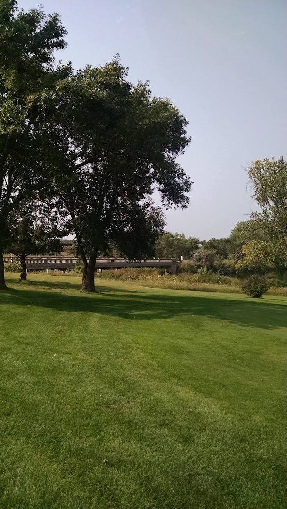 Panoramic view of a lush green golf course at Lake Platte Golf Club. Smooth