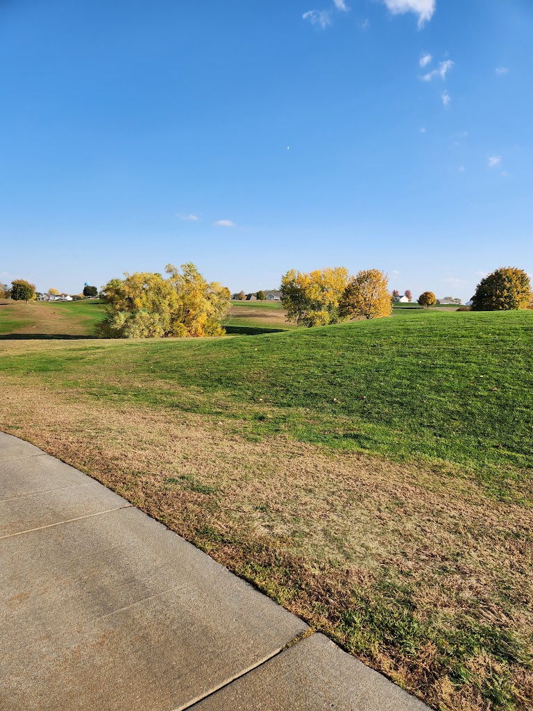 Panoramic view of a lush green golf course at Lake Ridge Golf Course. Smooth