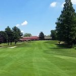 Panoramic view of a lush green golf course at Lake Success Golf Club. Smooth