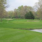 Panoramic view of a lush green golf course at Lake Tansi Golf Course. Smooth