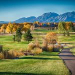 Panoramic view of a lush green golf course at Lake Valley Golf Club. Smooth