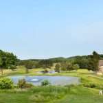 Panoramic view of a lush green golf course at LakeVue North Golf Course. Smooth