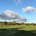 Panoramic view of a lush green golf course at Lakeside Country Golf Club. Smooth