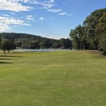 Panoramic view of a lush green golf course at Lakeside Golf Course. Smooth