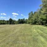 Panoramic view of a lush green golf course at Lakewood Golf Course. Smooth