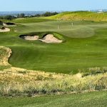 Panoramic view of a lush green golf course at Landmand Golf Club. Smooth